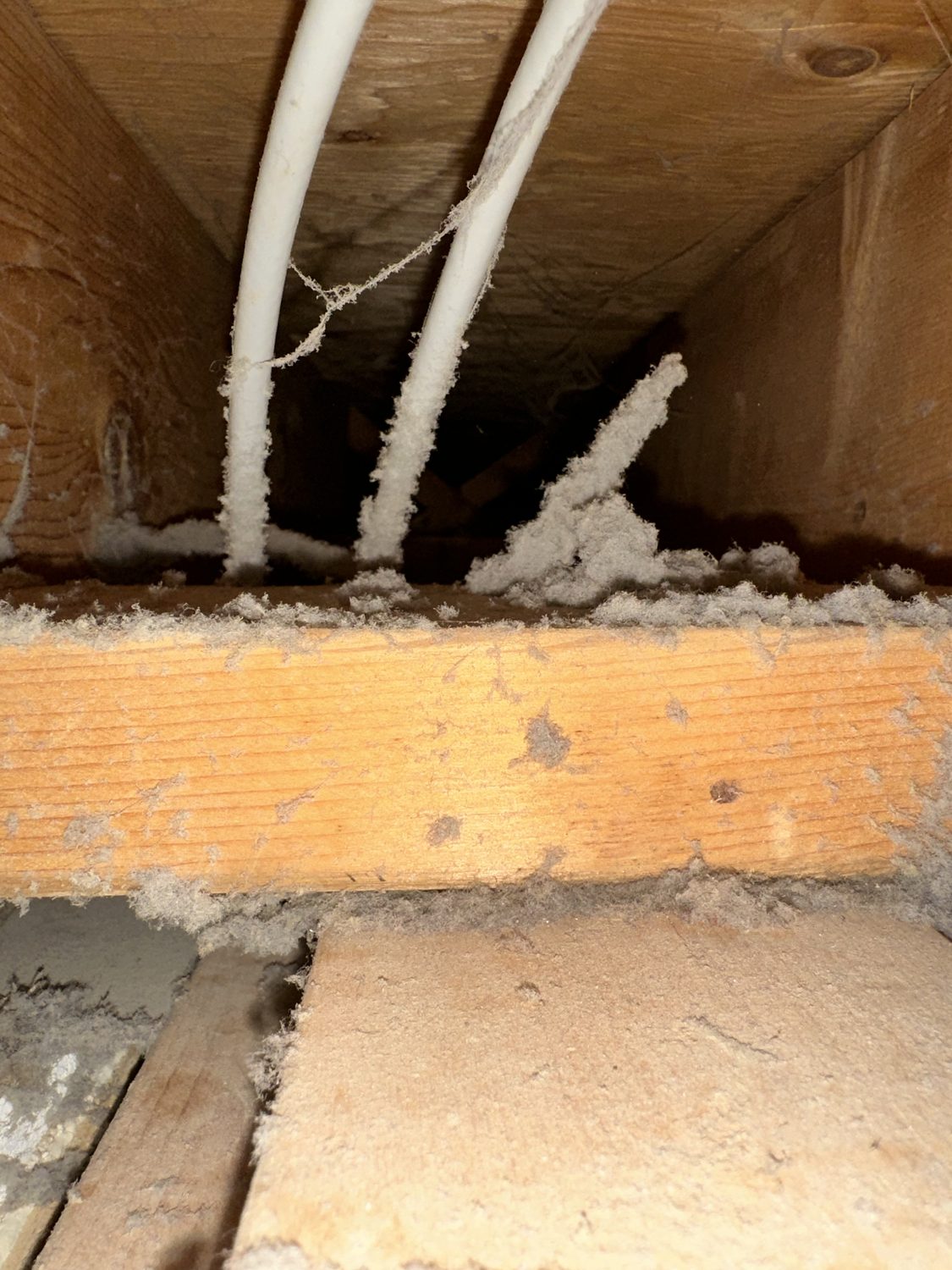 Ceiling vent and duct thick with buildup before cleaning