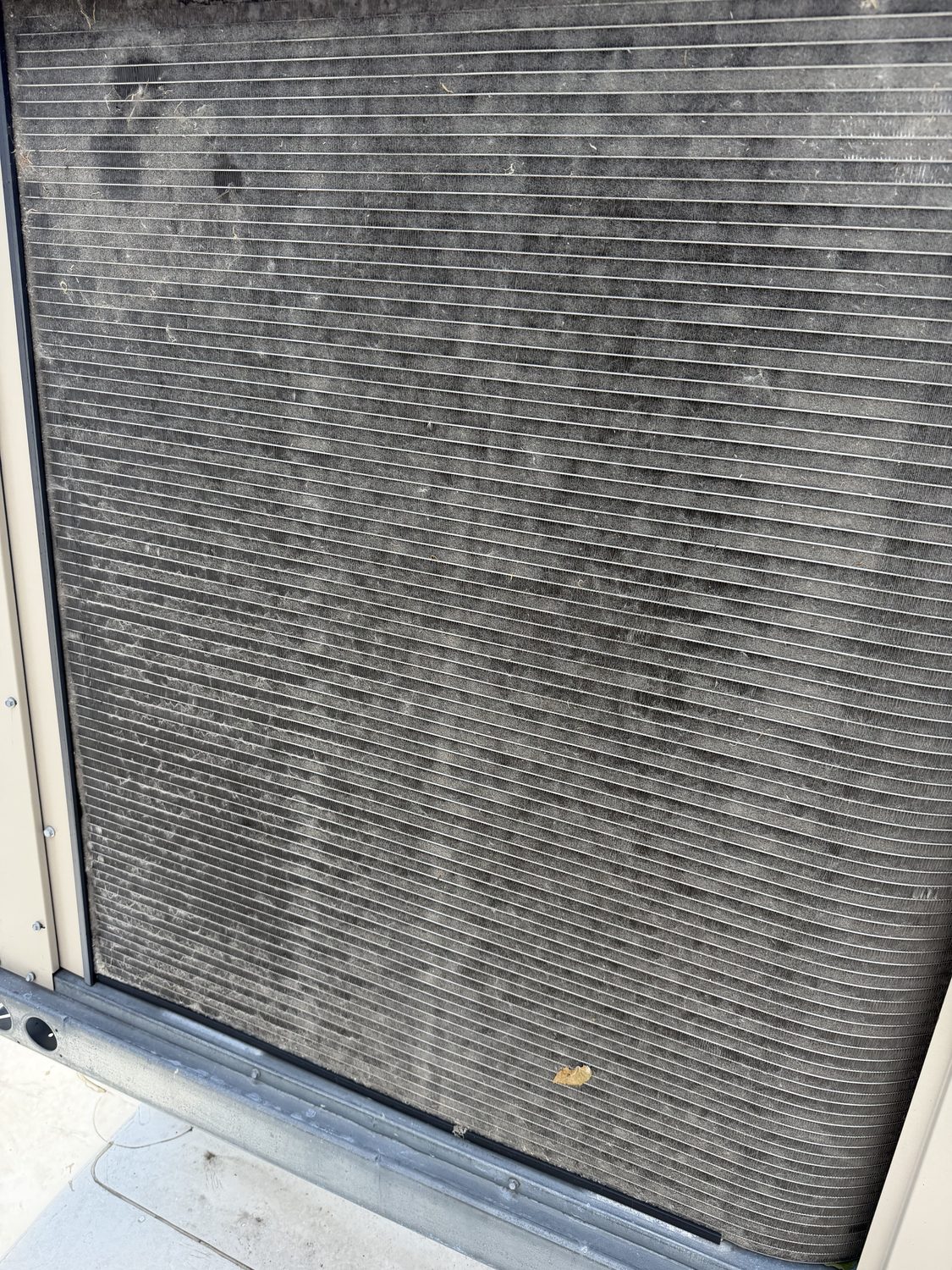 Exterior surface with dirt and staining before pressure washing